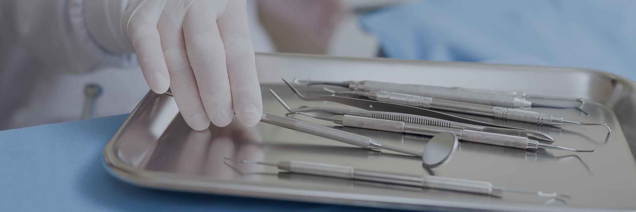Dentist selecting an instrument to use during a dental checkup