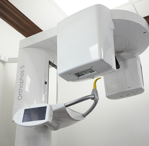 Cone beam CT scanner standing against a wall