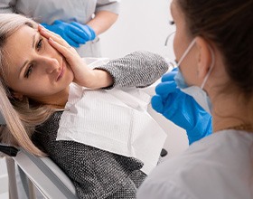 A young woman seeing a dentist for a toothache