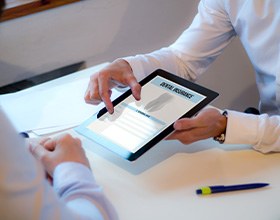 An insurance agent discussing dental insurance with a patient