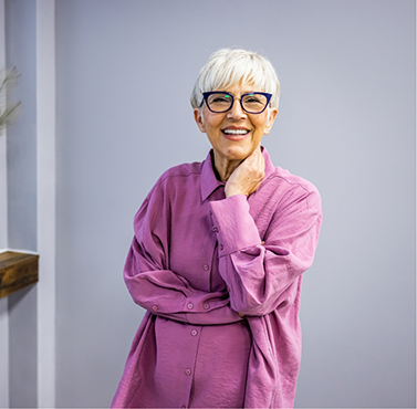 Smiling senior woman in a purple blouse