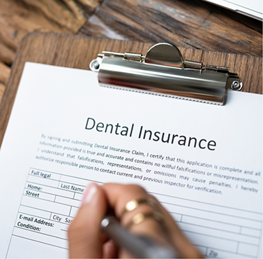 Person filling out a dental insurance form